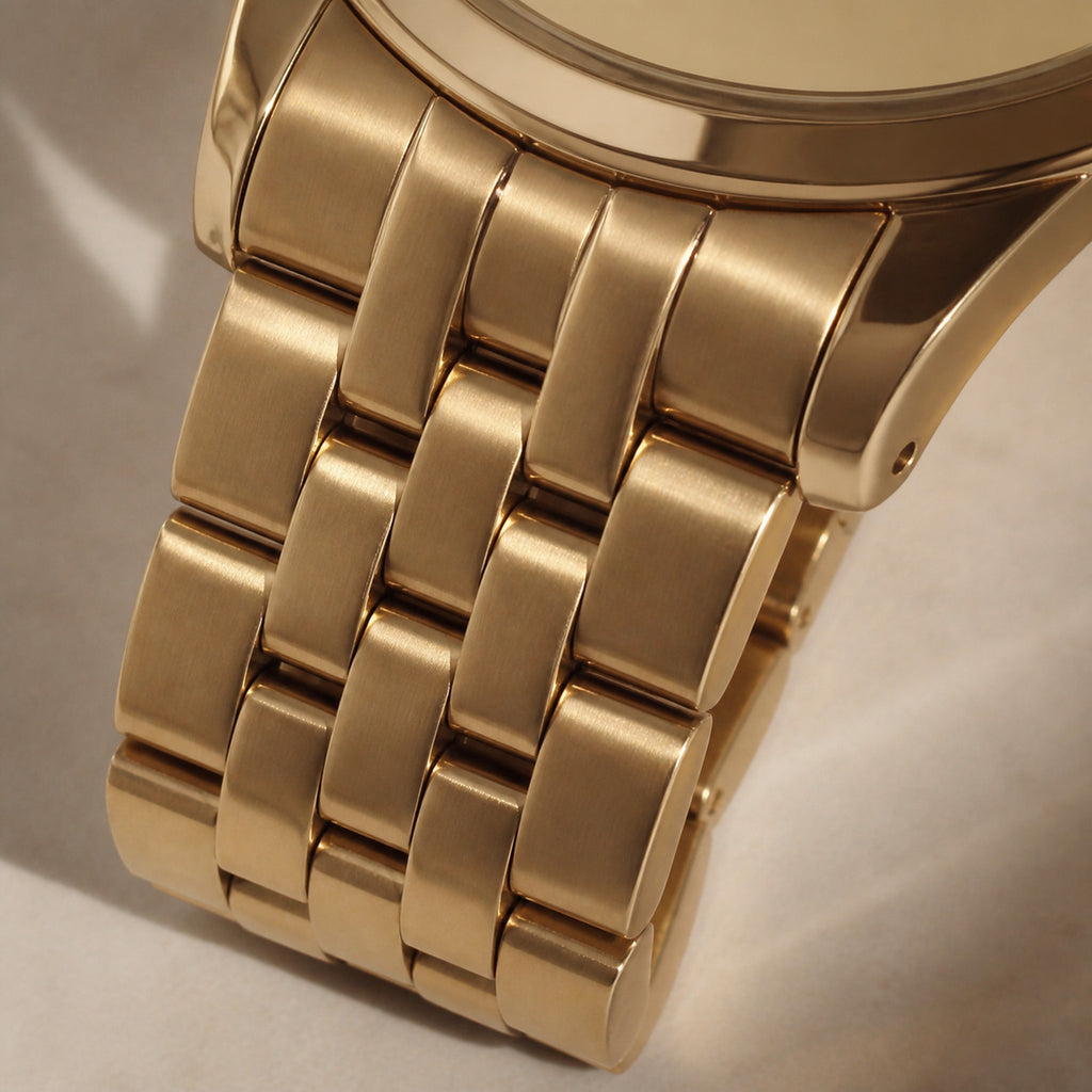 Trente-Six Or intégral — macro de la jonction boîtier-bracelet : boîtier, bracelet cinq rangs et cadran dans la même teinte or jaune, relief donné par l'alternance satiné-poli des maillons — Maison Noirmont